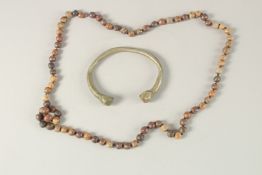 A STONE BEADED NECKLACE, together with an early metal bangle, (2).