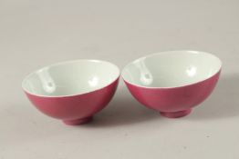 A PAIR OF CHINESE PINK GLAZE PORCELAIN TEACUPS, with character mark to base, 8.5cm diameter.