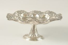 A PERSIAN ENGRAVED AND CHASED SOLID SILVER FOOTED CENTREPIECE, with detachable stand, the bowl