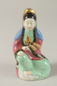 A CHINESE POLYCHROME PORCELAIN GUANYIN FIGURE, in seated position with gilded highlights, 15cm