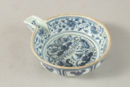 A CHINESE BLUE AND WHITE PORCELAIN OIL POURER, painted with ducks and lotus, bowl 13cm diameter.