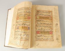 A FINE AND LARGE NORTH INDIAN MUGHAL LEATHER BOUND QURAN SIGNED ABD AL-LATIF BIN MULLA, dated 1098.