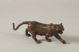 A BRONZE OKIMONO OF A TIGER, 15cm long.