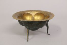 AN UNUSUAL POSSIBLY OTTOMAN TURKISH OR GREEK GILDED COPPER TOMBAK BOWL, raised on three curving