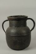 A LARGE EARLY ISLAMIC POSSIBLY SPANISH ADALUSIAN ENGRAVED TWIN HANDLE COPPER JAR, 35cm high.