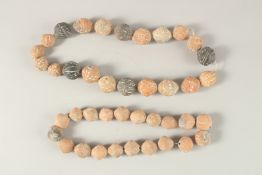 TWO CARVED TERRACOTTA BEADED NECKLACES.