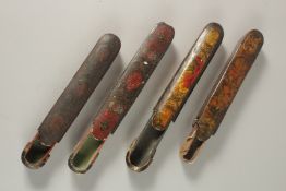 A COLLECTION OF FOUR 19TH CENTURY PERSIAN PAPIER MACHE PEN BOXES, some signed, one with secret