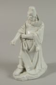 A FINE BLANC-DE-CHINE FIGURE of a bearded man, 21cm high.