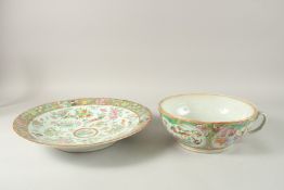 A CHINESE CANTON FAMILLE ROSE PORCELAIN HANDLED BOWL AND DISH, the bowl possibly a chamber pot, 25cm