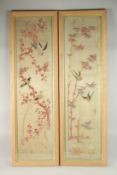 A FINE AND LARGE PAIR OF EMBROIDERED SILK PANELS, depicting birds on branches, each framed and