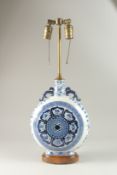 A CHINESE BLUE AND WHITE PORCELAIN MOON FLASK LAMP, decorated with luck symbols, 59cm high overall.