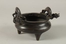 A CHINESE BRONZE TRIPOD CENSER, with twin dragon-form handles, the base with character mark, 17.