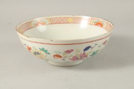 A CHINESE POLYCHROME PORCELAIN BOWL, enamel painted with native flora, 23cm diameter.