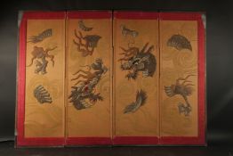 A CHINESE FOUR PANEL EMBROIDERED AND PADDED SILK OVERLAID SCREEN, depicting two dragons amongst