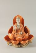 A LARGE CHINESE PART-GLAZED PORCELAIN GUANYIN SITTING ON A LOTUS BASE, 31.5cm high.