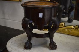 A jardiniere or urn stand on cabriole legs with claw and ball feet.