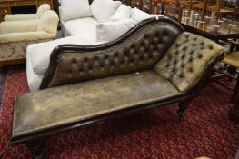 A Victorian chaise longue with buttoned and brass studded leather upholstery.