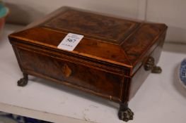 A good small 19th century work box or jewellery casket on paw feet.