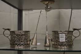 A pair of plated chamber sticks with pierced sides complete with snuffers.