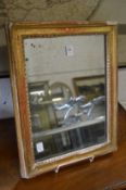 A small gilt framed mirror.