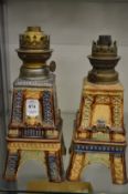 An unusual pair of Victorian Eiffel tower formed salt glazed pottery oil lamp bases.
