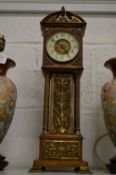 A good oak and brass miniature long case clock.