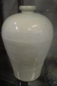 A large Chinese celadon glazed vase with incised decoration.