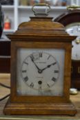A small oak cased mantel clock.