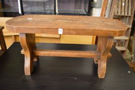 A hardwood stool and two-tier coffee table.