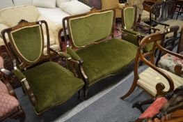 An Edwardian inlaid mahogany three piece suite.