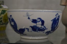A Chinese blue and white bowl decorated with figures.