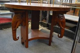 A mahogany circular centre table, the three plank supports with elephant head decoration.
