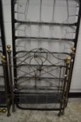 A Victorian style 3ft wrought and cast iron bed frame with brass finials and sprung base.