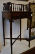 A good rosewood floor standing book trough with two small drawers.