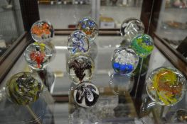 A good collection of twelve glass paperweights.