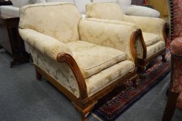 A pair of deep armchairs with carved walnut show wood frames.