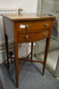 A small mahogany serpentine fronted two drawer table.