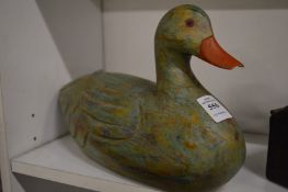 Carved and painted wooden model of a duck.