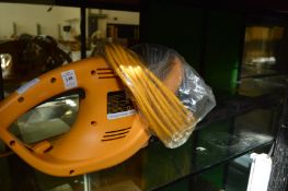A JCB electric hedge trimmer.