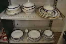 Quantity of Wedgwood dinnerware with blue and gilt borders.