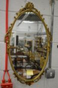 A small gilt framed mirror.