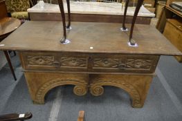 An unusual 18th century Tuscan oak table with over-hanging top, carved drawer on a carved base.