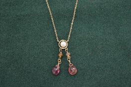 A gold and gem set necklace.