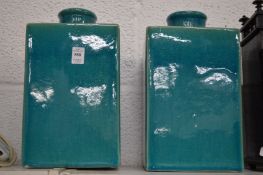 A large pair of turquoise glazed square shaped pottery canisters and covers.