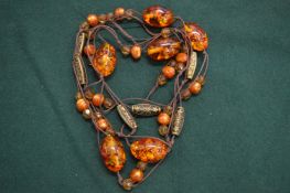 An amber necklace with five large amber beads.