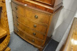 A small bow front chest of drawers.