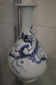 A Chinese blue and white bottle vase decorated with a dragon.