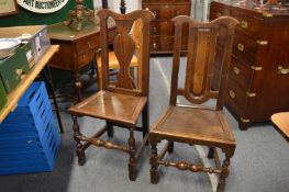 Two 18th century oak dining chairs.