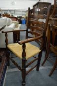 A good set of ten oak and rush seated ladder back dining chairs, two with arms.