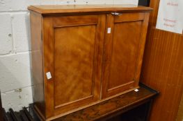 A satin wood two door cabinet.